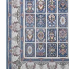 A Qaleen Carpets rug with a blue and white patterned design, featuring intricate patterns and a border of flowers and leaves