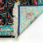 A close-up of a Qaleen Carpets rug's corner, showcasing its intricate design and rich colors