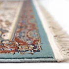 A close-up of a Qaleen Carpets rug, showcasing its intricate patterns and vibrant colors