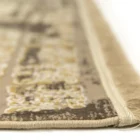 A close-up of the edge of a Qaleen Carpets rug, with a focus on the intricate design and the soft, frayed edge