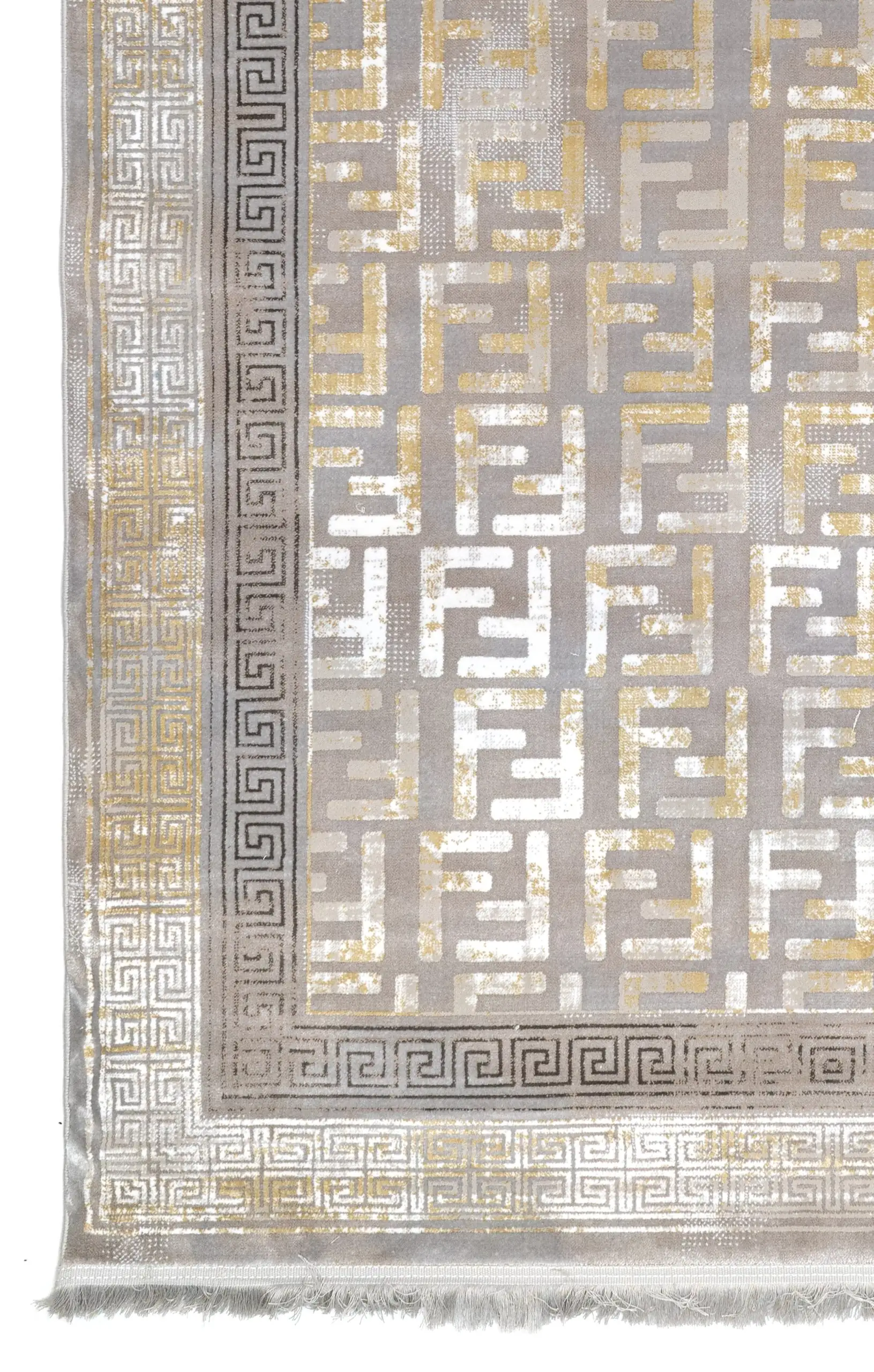 A close-up of a Qaleen Carpets rug with a traditional design, featuring a mix of gold and silver patterns on a grey
