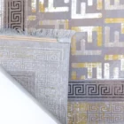 A close-up of a rug's corner, with a patterned design and frayed edges, made by Qaleen Carpets