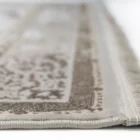 A close-up of a Qaleen Carpets rug with a soft, neutral color palette and intricate patterns, showcasing its high-quality