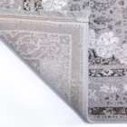 A close-up of a rug's corner, showcasing its intricate patterns and Qaleen Carpets' quality