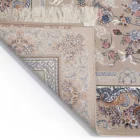 A close-up of a Qaleen Carpets rug with a floral pattern, featuring a mix of pastel colors and a fringe at the top