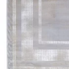 A close-up of a Qaleen Carpets rug with a geometric pattern, featuring a mix of light and dark grey hues, with a subtle