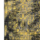 A close-up of a Qaleen Carpets rug with a black and gold pattern, featuring a mix of traditional and modern elements, with a