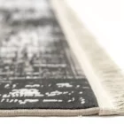 A close-up of a rug's edge, with a focus on the fringe and the rug's pattern, made by Qaleen Carpets