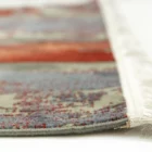 A close-up view of a Qaleen Carpets rug, showcasing its intricate patterns and colors