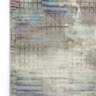 A close-up of a Qaleen Carpets rug with a unique, intricate design, featuring a mix of colors and patterns, showcasing the