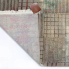 A Qaleen Carpets rug with a unique blend of traditional and modern design elements, featuring a mix of colors and patterns,