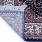 Carpets A close-up of a rug's corner, showcasing its intricate carpet design and delicate carpeting