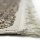 A close-up of a Qaleen Carpets rug's intricate, hand-knotted design, showcasing its beauty and craftsmanship