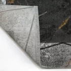 A close-up of a rug's corner, revealing its intricate design and Qaleen Carpets' quality
