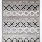 A high-quality, intricately designed rug with a mix of grey, white, and black patterns, made by Qaleen Carpets