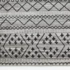 A close-up of a gray and white area rug with a geometric pattern, made by Qaleen Carpets