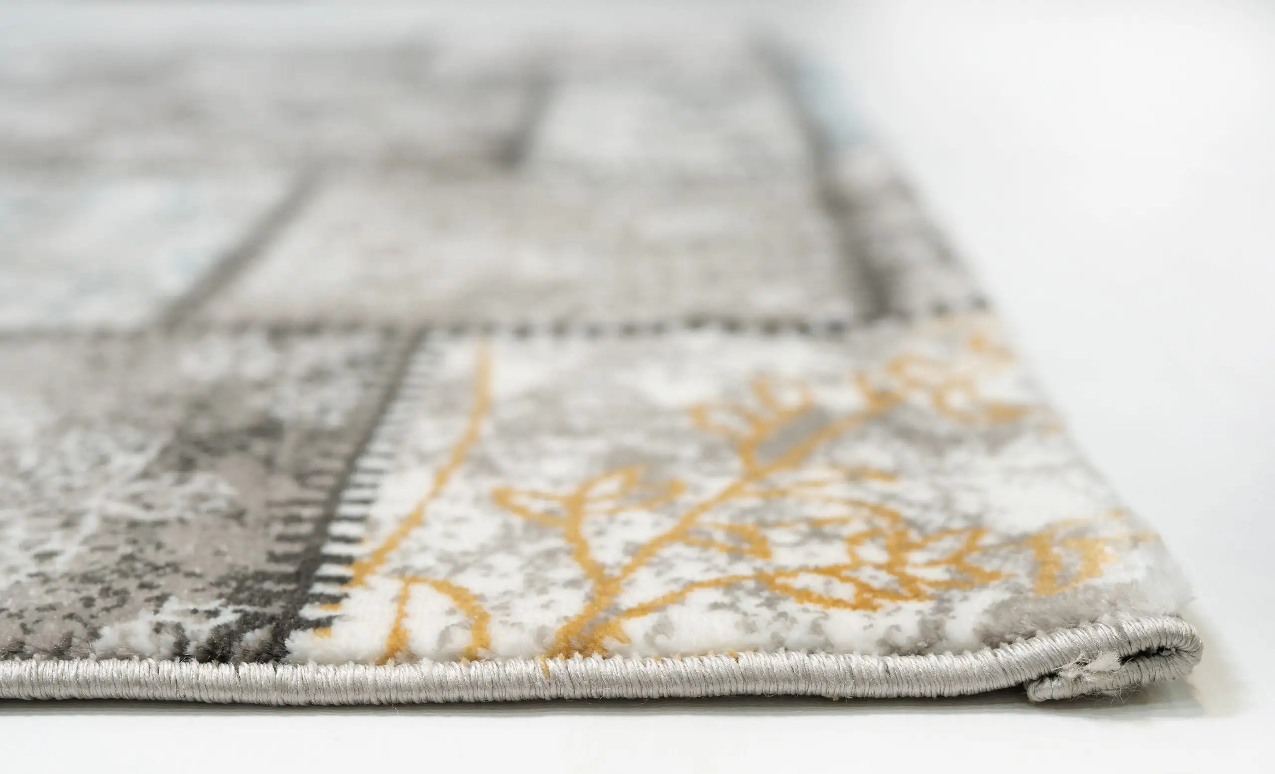 Carpets A close-up of a carpet's edge, showcasing its intricate design and soft, plush texture