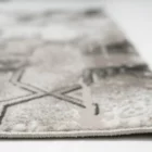 A close-up of a Qaleen Carpets rug, with a focus on its intricate design and texture, showcasing its high-quality and unique