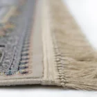 A close-up of a Qaleen Carpets rug with intricate patterns and fringes, showcasing its high-quality design and craftsmanship