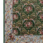 Carpets A beautiful, intricately designed carpet with a green background and intricate floral patterns