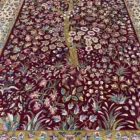Carpets A beautiful, intricately designed carpet with a rich, deep red background and a golden border