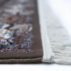 A close-up view of a Qaleen Carpets rug, showcasing its intricate design and rich colors