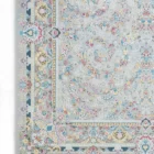 A Qaleen Carpets rug with a light grey background and a floral pattern in pastel colors, including pink, blue, and yellow,