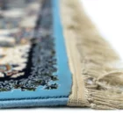 A close-up of a carpet's edge, with a blue border and intricate patterns, showcasing the beauty of carpets and rugs
