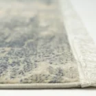 A close-up of a rug with a fringe on its edge, made by Qaleen Carpets