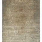 A Qaleen Carpets rug with a distressed, vintage-inspired design in a neutral color palette, featuring a mix of soft, muted