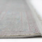 A close-up view of a Qaleen Carpets rug, showcasing its intricate patterns and soft, natural colors
