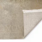 Carpets A beige and gold patterned rug with a subtle, intricate design