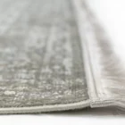 A close-up of a Qaleen Carpets rug's edge, with a focus on its fringe and border