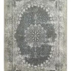 Carpets A rug with a distressed, vintage-inspired design, featuring a central floral pattern in a mix of blue and white,
