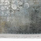 Qaleen Carpets A close-up of a rug with a light blue and gold pattern, with a white fringe at the bottom