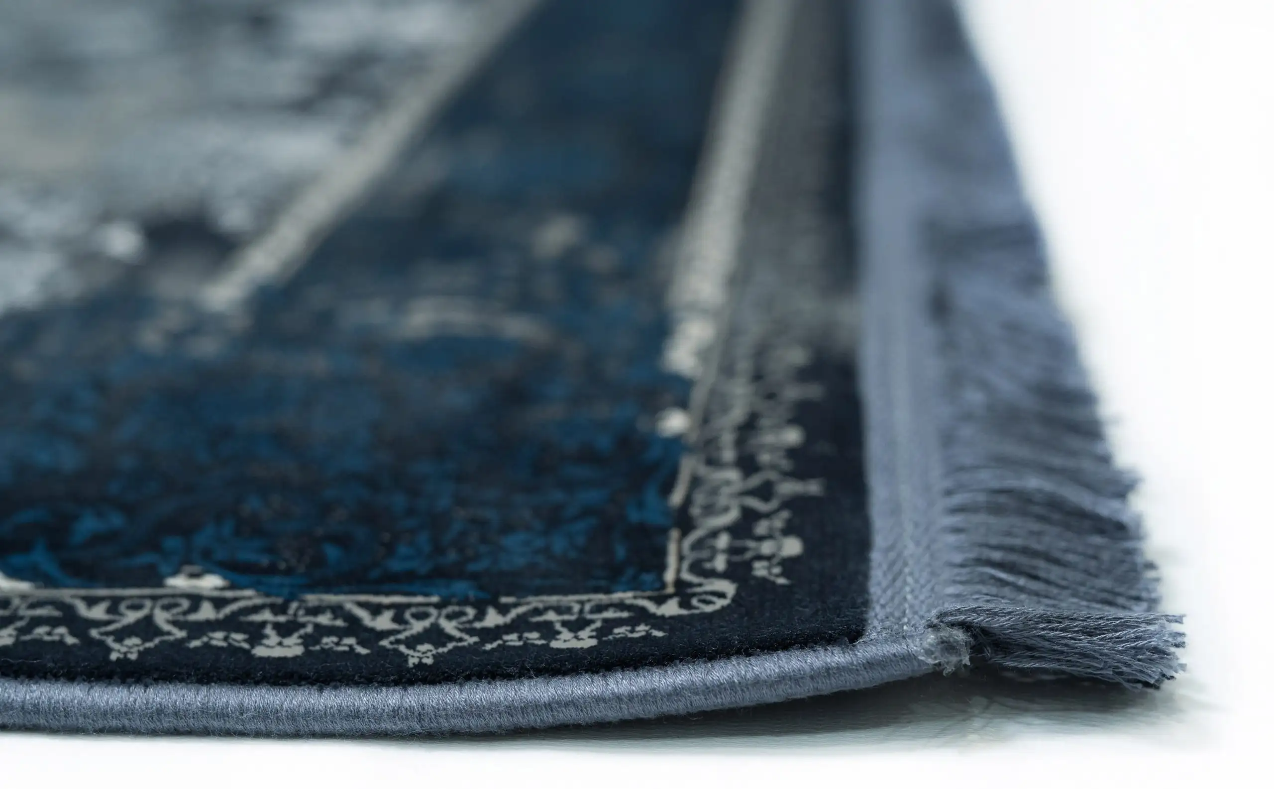 Carpets A close-up of a rug's edge, showcasing its intricate design and carpet-like texture