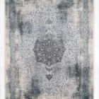 A Qaleen Carpets rug with a central medallion and intricate border, featuring a mix of blue and white patterns on a cream