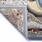 Carpets A beautiful, intricately designed carpet with a mix of colors and patterns, with a corner folded and a part of the