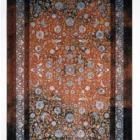 Carpets A vibrant, intricately patterned rug with a mix of red, gold, and blue hues, featuring a central design of flowers