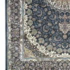 Carpets A beautiful, intricately designed carpet with a rich, dark blue background and intricate patterns of gold and white