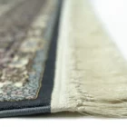 A close-up view of a Qaleen Carpets rug, focusing on its intricate design and fringe details