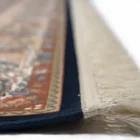 A close-up of a rug's edge, with a focus on the intricate carpeting and rug's design, showcasing the beauty of carpets and