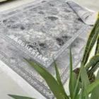 Carpets A rug with a floral pattern in various shades of blue and white, surrounded by a border of the same pattern in a