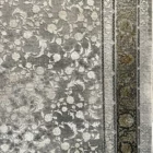 Carpets A beautiful, intricately designed carpet with a mix of dark and light colors, featuring a central pattern of flowers