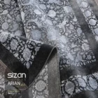 Carpets A close-up of a dark, patterned carpet with a floral design, with a rolled-up section in the foreground