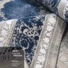 Carpets A close-up of a blue and white carpet with a floral pattern, with a focus on the intricate details of the design