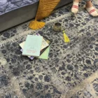 Carpets A person's feet on a rug with a book, a cup, and a rug in the background, with a focus on the rug and the person’s