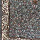 A beautiful, intricately designed carpet with a mix of flowers and leaves, made of high-quality materials, perfect for