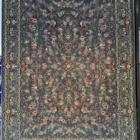 A beautiful, intricately designed carpet with a rich, vibrant pattern, perfect for adding a touch of elegance to any room,