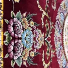 Carpets A close-up of a red carpet with a floral pattern
